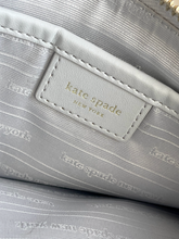 Load image into Gallery viewer, Close-up of the interior of a handbag, showing a light gray patterned lining and leather label with 'kate spade NEW YORK'